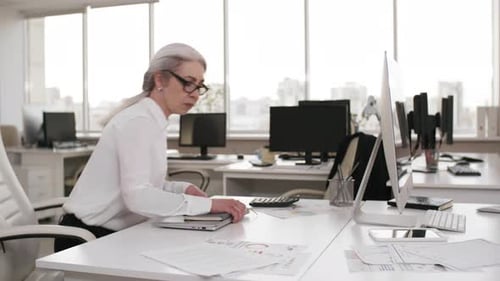 Ambitious Caucasian Businesswoman Working Overtime in Empty Office