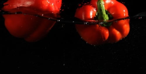 Red Bell Peppers Dropped in Water Tank