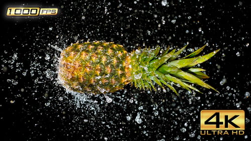 Pineapple gets splashed with water in slow motion
