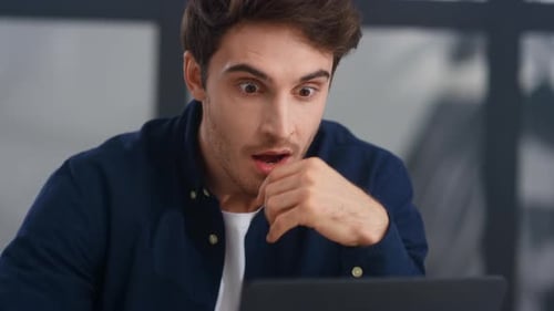 Surprised Businessman Getting Good News Letter on Computer in Office.