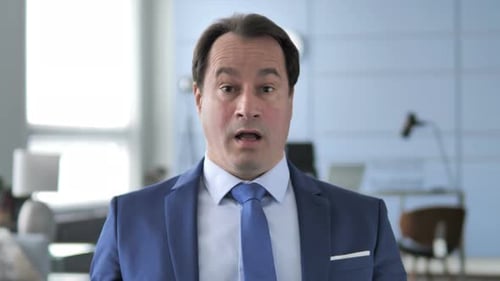 Businessman Talking in Office Setting