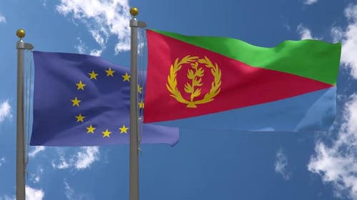 European Union and Eritrea Flags Waving Against Blue Sky