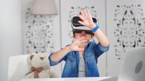 Boy Wearing VR Headset Gesturing with Hands