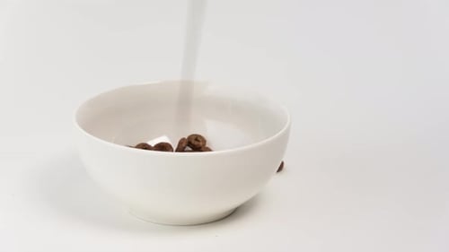 Chocolate Ring Cereal Filling a White Bowl
