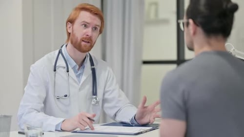 Doctor Discussing Results with Patient at Desk