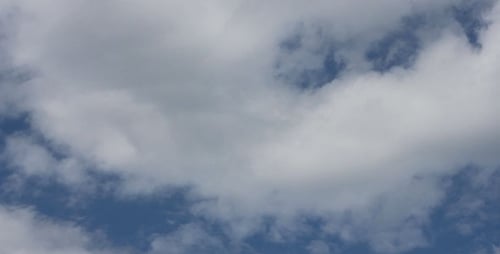 Clouds Drifting Gently Across a Blue Sky