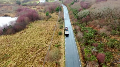 Aerial View of Tractor and Trailer Driving on Rural Road in Ireland