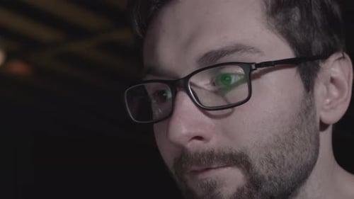 Attractive effective office worker working hard at his cabinet late at night
