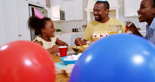 Happy Family Celebrates Birthday at Home With Cake