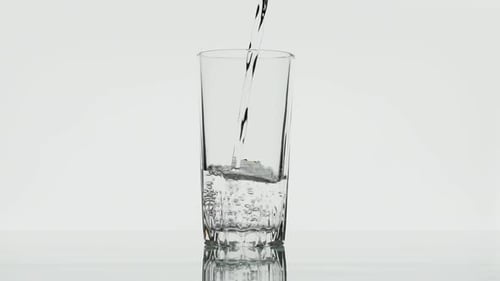 Water Pouring into Glass Cup With Bubbles