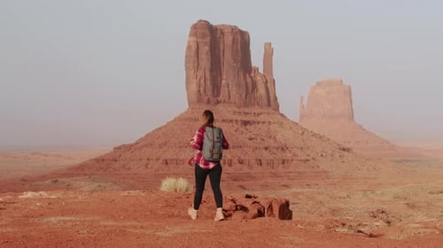 Cinematic Female Traveler Walking in Scenic Red Desert Park Landscape View