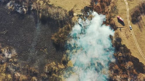 Aerial View. Spring Dry Grass Burns During Drought Hot Weather. Bush Fire And Smoke. Fire Engine