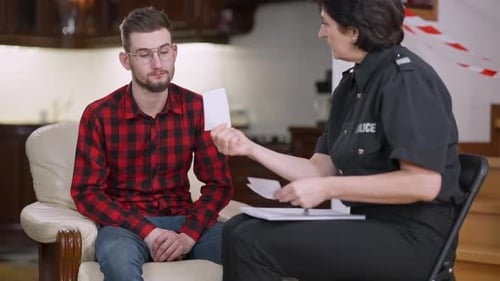 Police Interviewing Young Adult Male in Interior Setting
