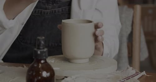 Potter Shapes Clay into Mug on Pottery Wheel