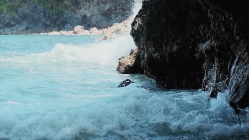 Static slow-motion of powerful blue waves from Pacific Ocean crashing on rock wall of Hawaiian coast