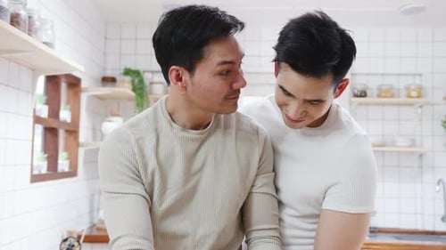 Gay Couple Share Loving Moment in Kitchen