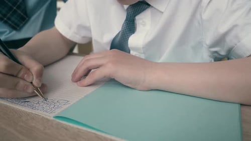 Schoolchildren Do Homework Write Numbers in Notebook