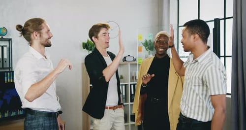 Team Celebrates in an Office With High Five