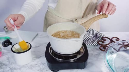 Step by step. Caramelizing sugar in a small cooking pot over the small electric stove