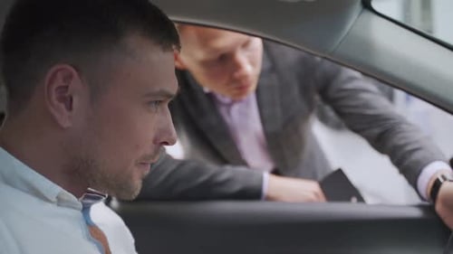 Man Talking To the Salesman at the Car Dealership While Choosing a New Auto Communication Positivity