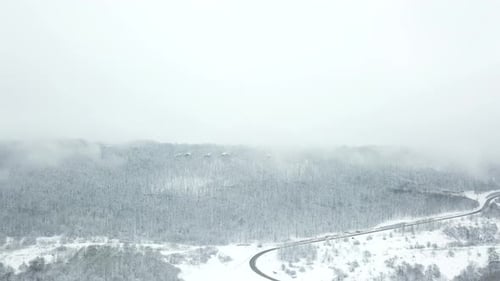 Drones Eye View Winding Road From the High Mountain Pass in Winter
