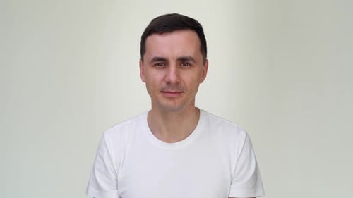 Man Pointing to the Side, White T-Shirt