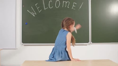 Back To School Concept. Schoolgirl Chalkboard in Classroom.
