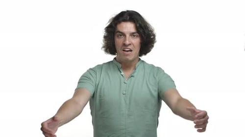 Video of Adult Hispanic Man in Green Shirt Shouting and Shaking Hands Rooting for Sports Team
