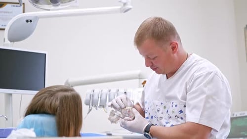 Woman sitting at dental chair. Young female patient visiting dentist office