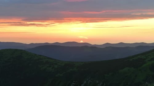 Majestic Sunrise Over Green Mountain Range