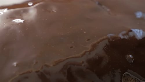 Chocolate cake adding glaze on top 4K 3840X2160 UltraHD footage - Adding melted chocolate on top of