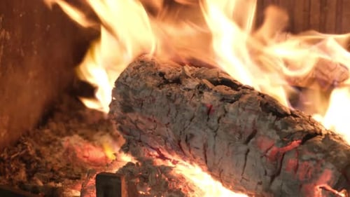 Firewood is Burning in a Cozy Fireplace