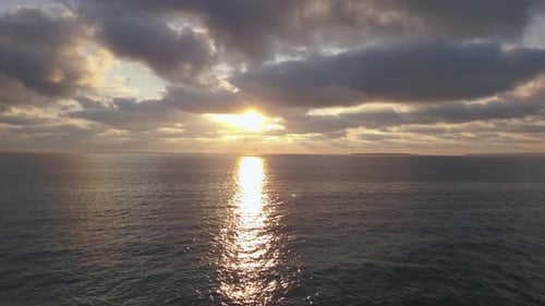 Dramatic sun rays in the clouds above a calm sea