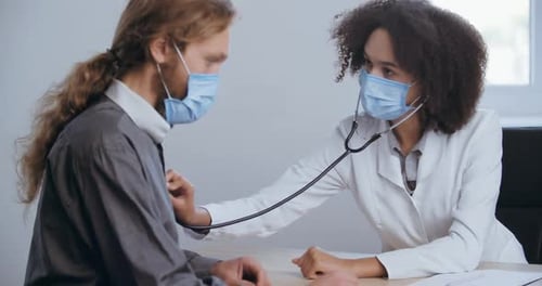 Doctor Examines Patient With Stethoscope at Clinic