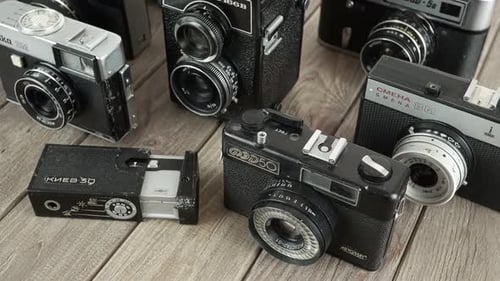 Collection of Vintage Cameras on Wooden Surface