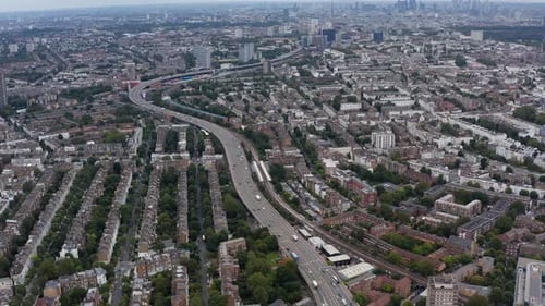 Wide Panoramic View of Residential Borough Busy Highway and Tilt Up Reveal of Downtown Skyline