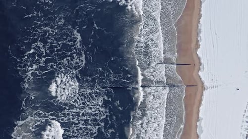 Winter snowy beach at Baltic sea. Aerial view of Poland