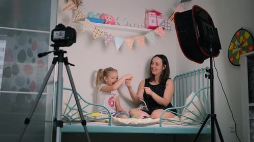Little Girl with Mom Records New Content for Vlog