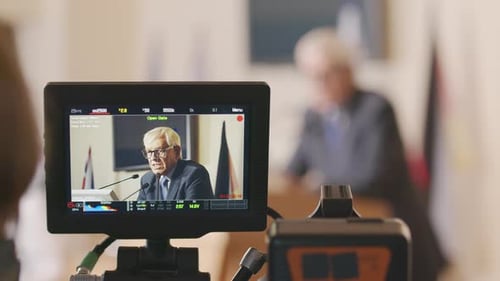 Senior Man Giving Speech at Press Conference
