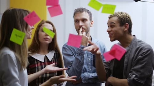 Diverse Team Brainstorming Ideas and High Fiving in Office