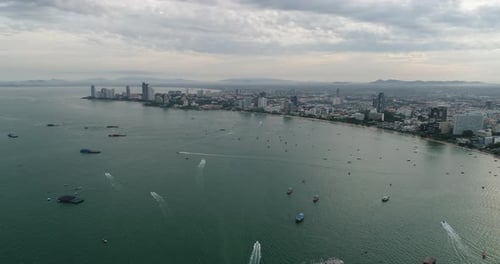 Aerial view of speed boats on the sea near beach city