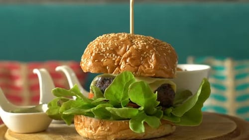 Close-up of Burger with Fries and Sauces
