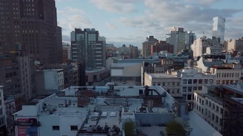 Sliding Reveal of Traffic on Wide Multilane Street Between Tall Buildings in Large City