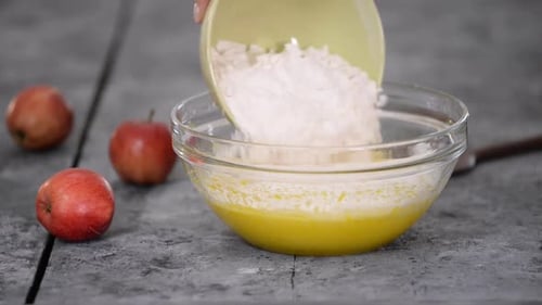Adding Flour to Batter in a Bowl