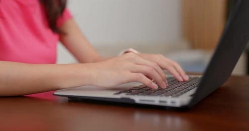 Hands Typing on Laptop at Home