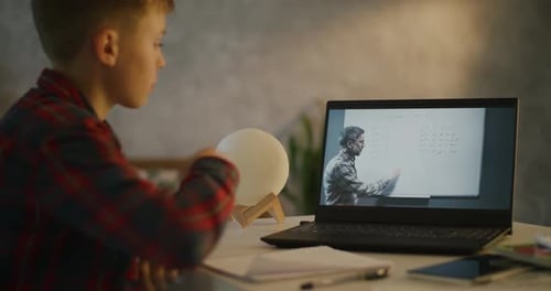 Boy Watches Online Math Lesson on Laptop