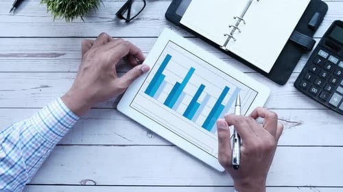 Top View of Businessman Analyzing Bar Chart on Digital Tablet