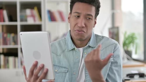 Young Adult Video Calling with Tablet Indoors