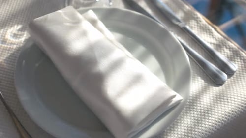 Elegant Table Setting with White Dinnerware and Silverware
