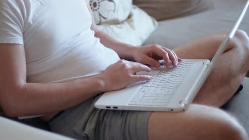 Person Typing on Laptop Computer at Home